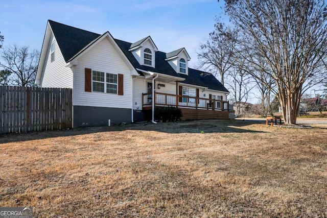 view of front of home featuring a front yard and a deck