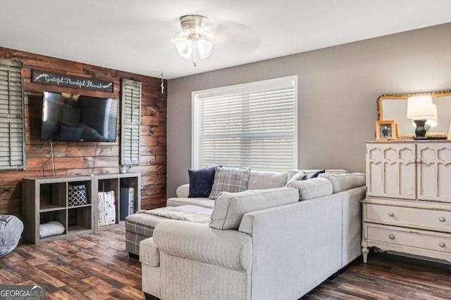 living room featuring ceiling fan and dark hardwood / wood-style flooring