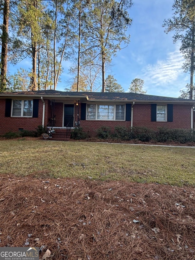 single story home featuring brick siding and a front yard