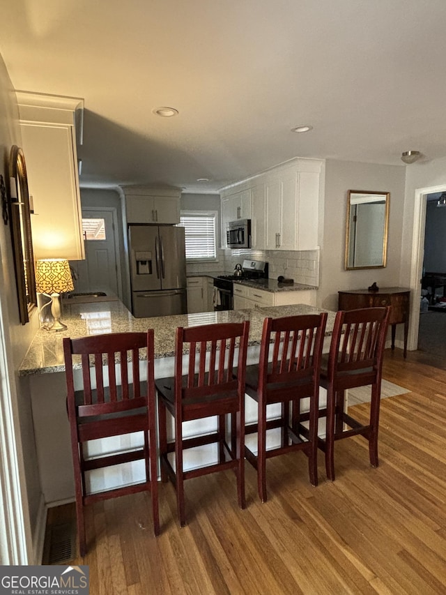 dining room featuring recessed lighting and wood finished floors