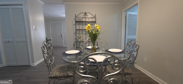 dining room with dark hardwood / wood-style flooring and crown molding