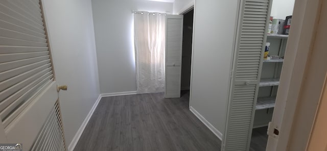 hallway with dark hardwood / wood-style floors