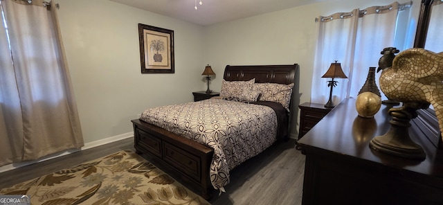 bedroom with dark hardwood / wood-style flooring