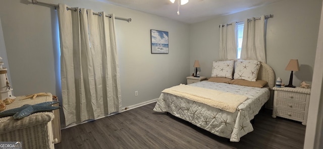 bedroom with dark hardwood / wood-style flooring