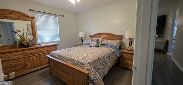 bedroom with dark hardwood / wood-style floors