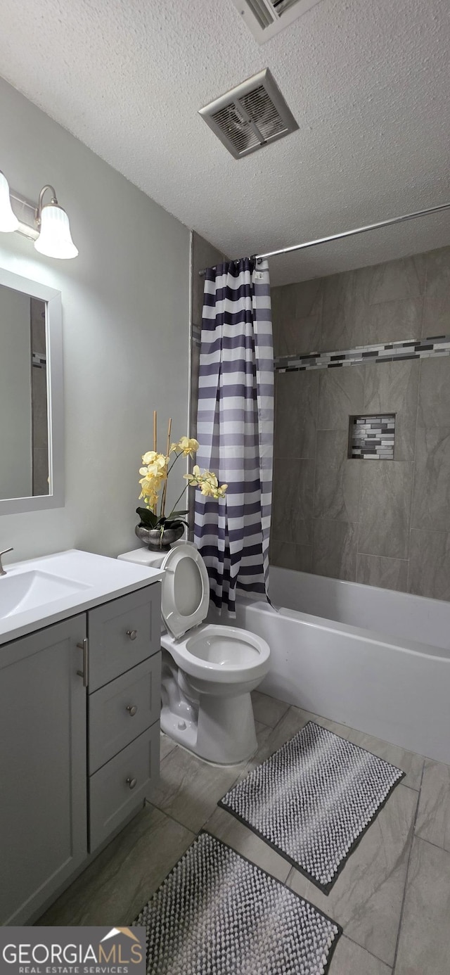 full bathroom featuring vanity, shower / bathtub combination with curtain, a textured ceiling, and toilet