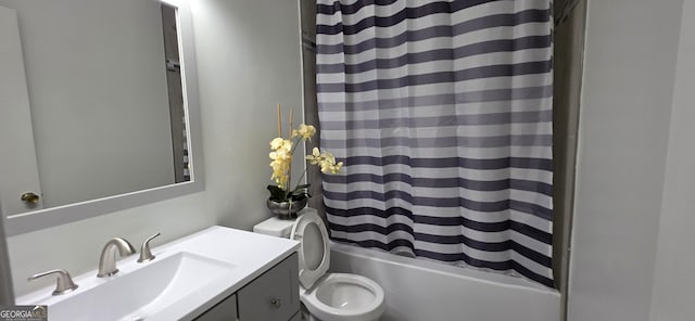 full bathroom with vanity, shower / tub combo with curtain, and toilet