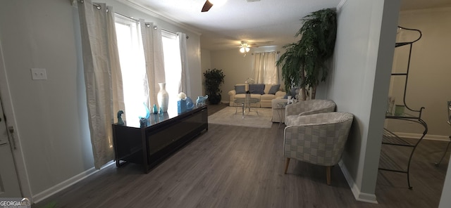 living room featuring ceiling fan, ornamental molding, and dark hardwood / wood-style flooring