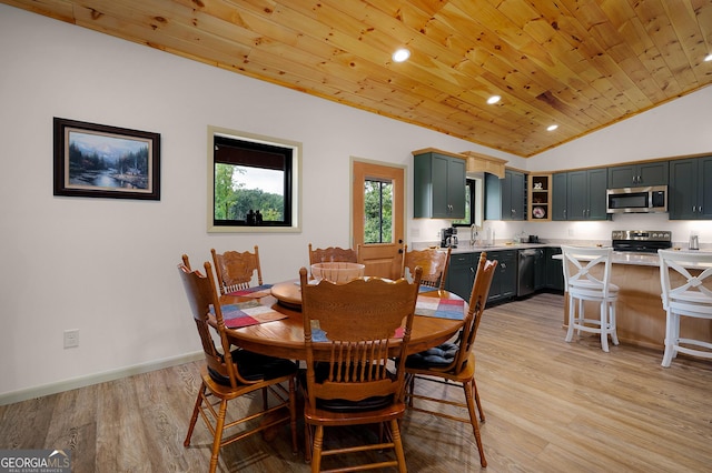 dining room featuring wood ceiling, sink, vaulted ceiling, and light wood-type flooring