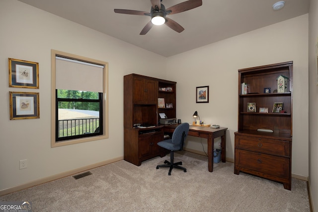 home office featuring light colored carpet and ceiling fan