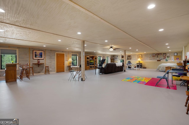 rec room featuring concrete flooring and ceiling fan