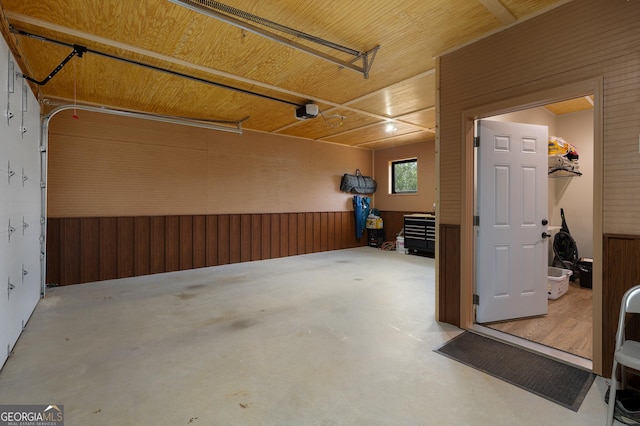 garage with wood ceiling and wood walls