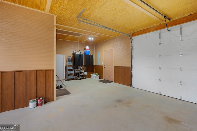 garage featuring wood walls