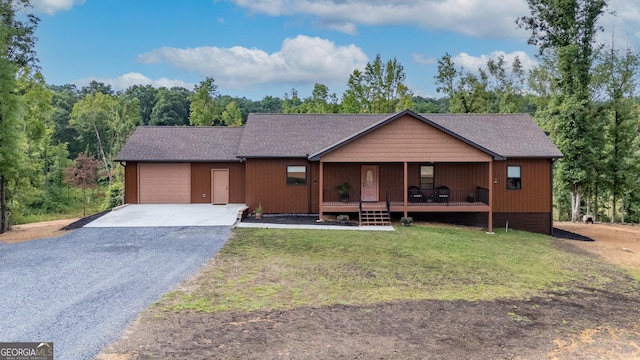 single story home with a garage, covered porch, and a front yard