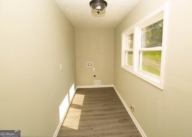 interior space with electric dryer hookup, visible vents, washer hookup, dark wood finished floors, and laundry area