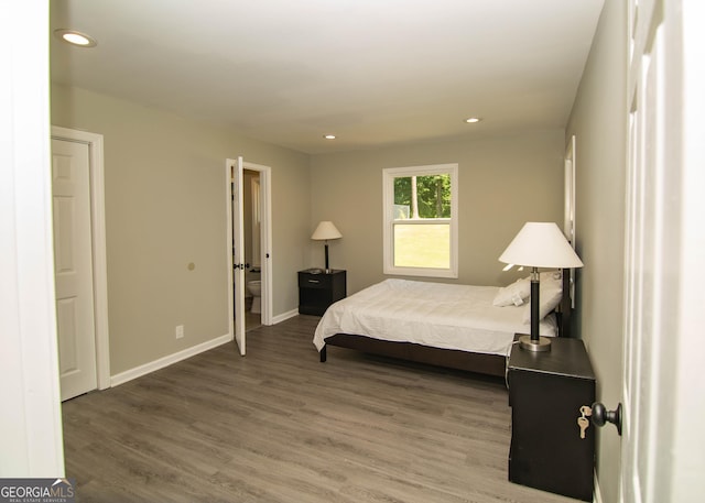 bedroom with recessed lighting, baseboards, and wood finished floors