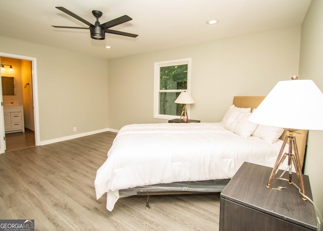 bedroom with a ceiling fan, wood finished floors, recessed lighting, connected bathroom, and baseboards