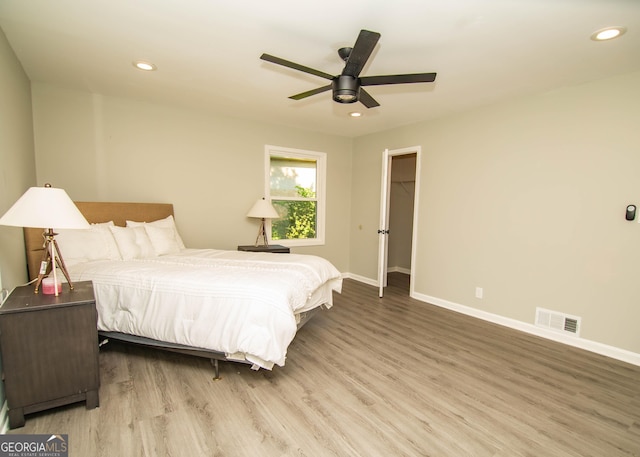 bedroom with a ceiling fan, wood finished floors, visible vents, baseboards, and recessed lighting