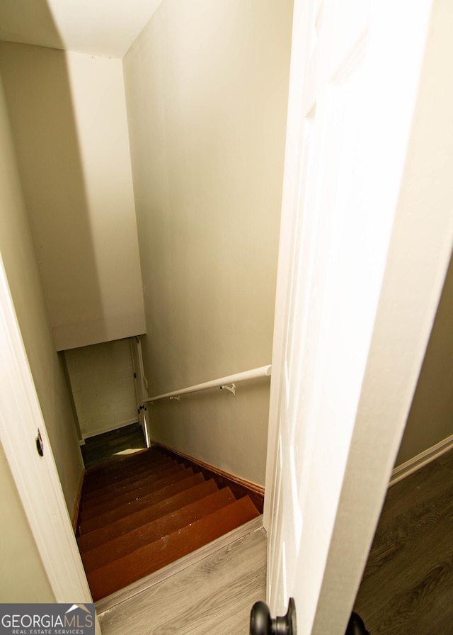 stairway with wood finished floors