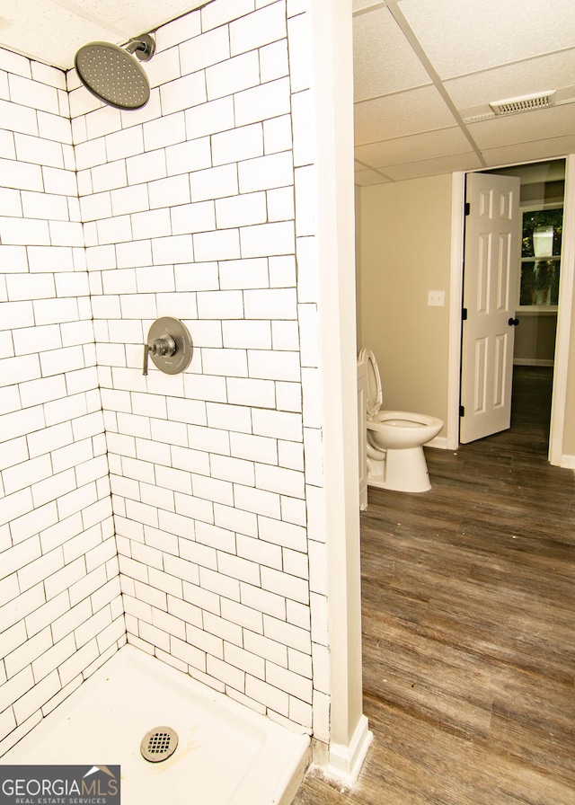 full bathroom with visible vents, a shower stall, and wood finished floors