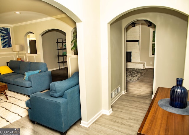 corridor with visible vents, baseboards, and light wood finished floors