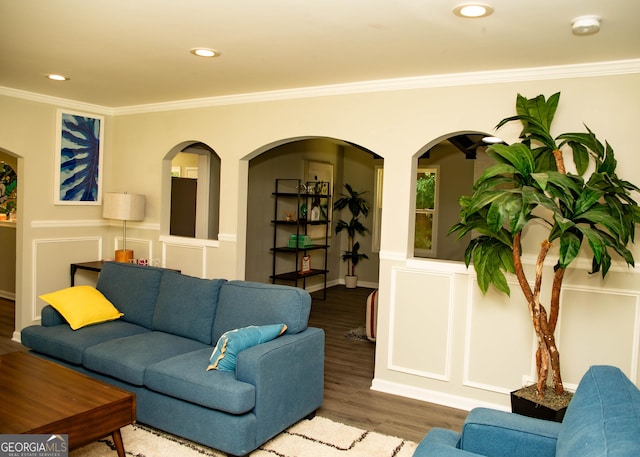 living area featuring crown molding, recessed lighting, and wood finished floors