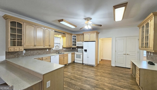 kitchen with tasteful backsplash, sink, kitchen peninsula, crown molding, and white appliances