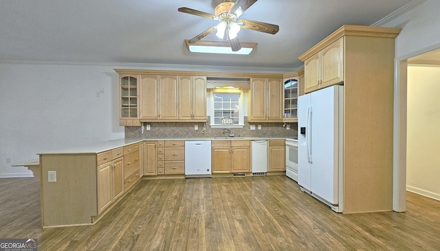 kitchen with dark wood-type flooring, white appliances, ornamental molding, and light brown cabinets