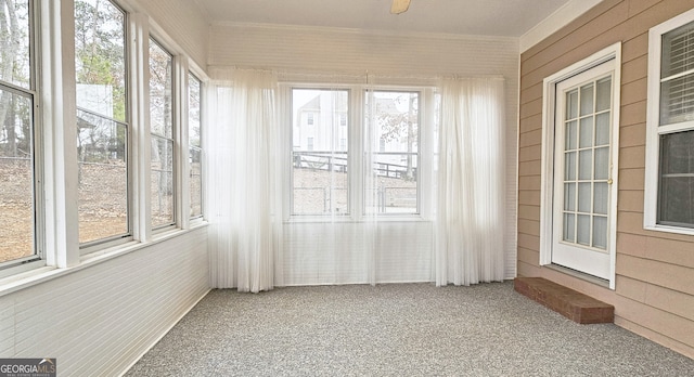 unfurnished sunroom featuring plenty of natural light