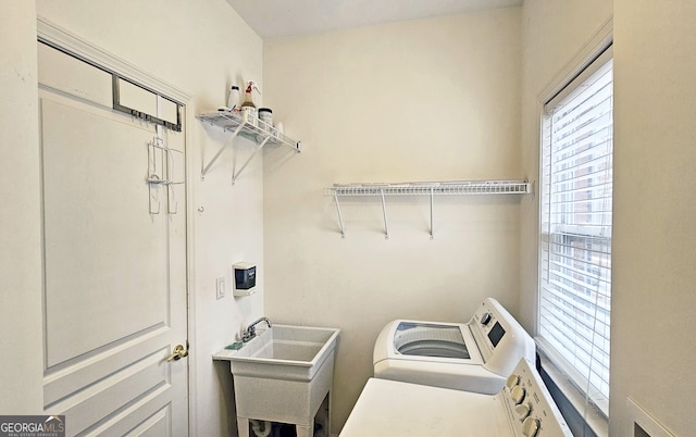 clothes washing area featuring sink and washing machine and dryer