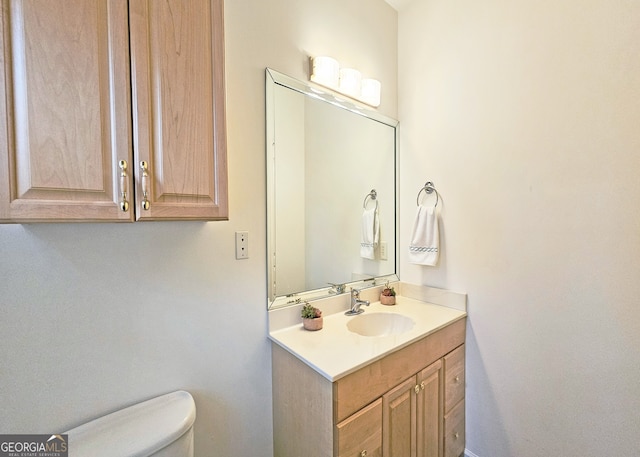 bathroom featuring vanity and toilet