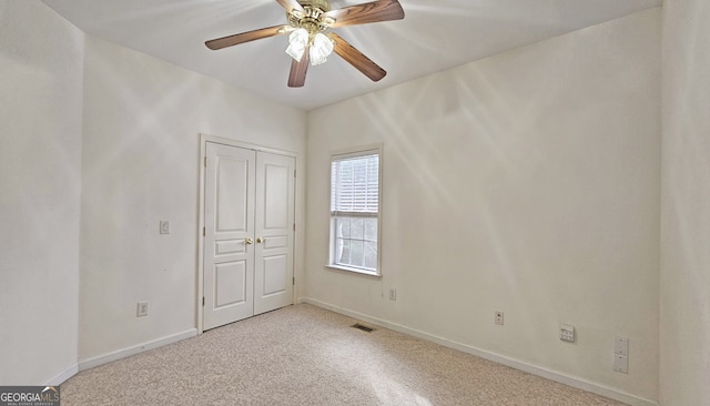 spare room with light carpet and ceiling fan