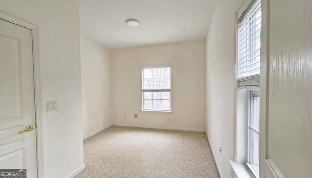 unfurnished room featuring light colored carpet