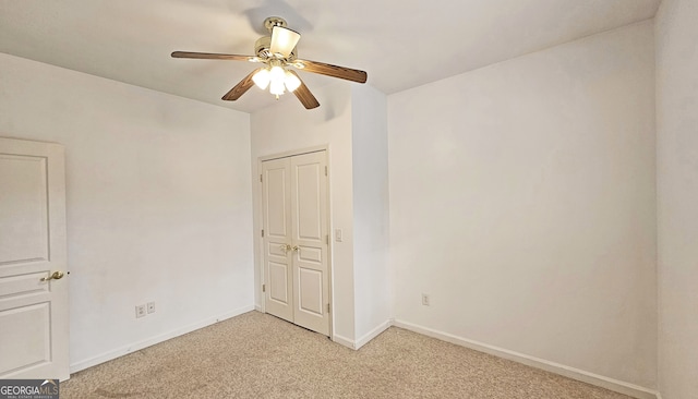 empty room featuring light carpet and ceiling fan