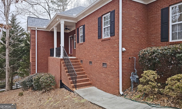 view of side of home with ceiling fan