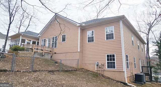 view of property exterior with central AC unit and a wooden deck