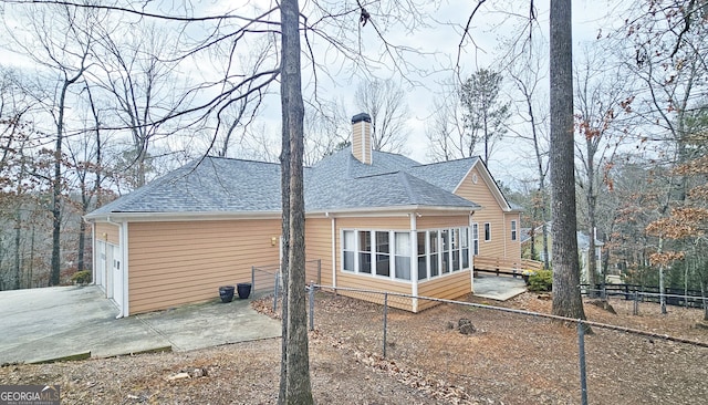 back of property with a sunroom