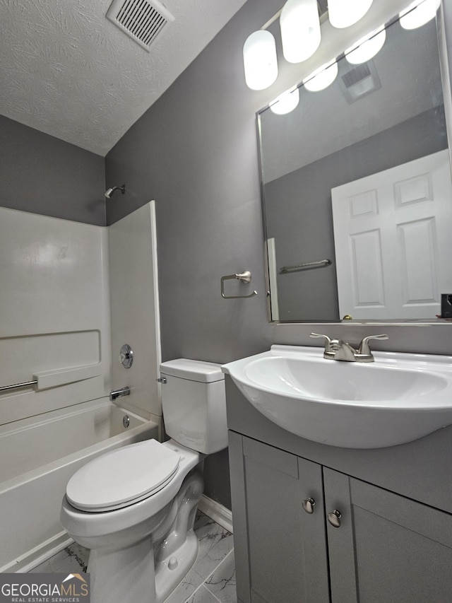 full bathroom with vanity, bathtub / shower combination, a textured ceiling, and toilet