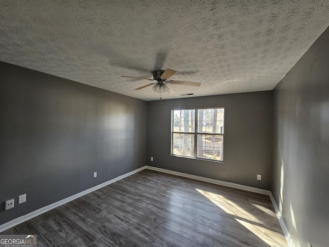 unfurnished room with dark hardwood / wood-style floors, a textured ceiling, and ceiling fan