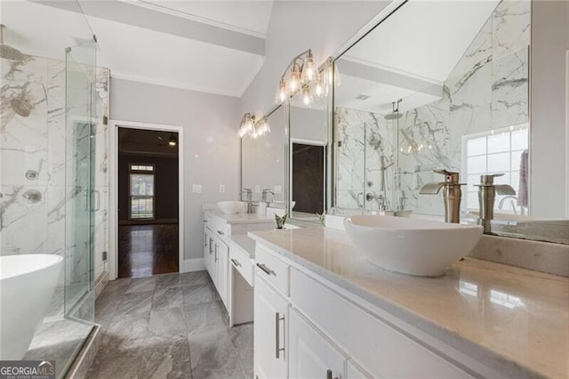 bathroom featuring vanity, a wealth of natural light, and vaulted ceiling