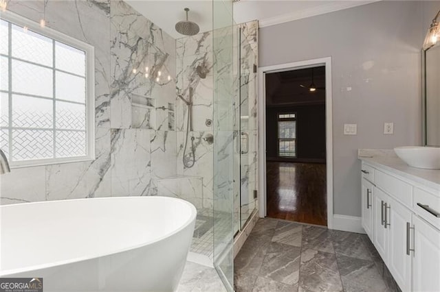 bathroom with independent shower and bath, vanity, a wealth of natural light, and crown molding