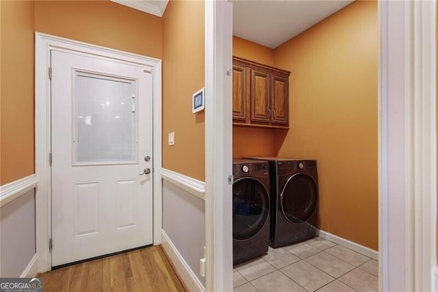 laundry room with cabinets, independent washer and dryer, and light hardwood / wood-style floors