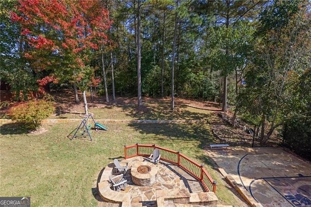 view of yard featuring a fire pit and a patio