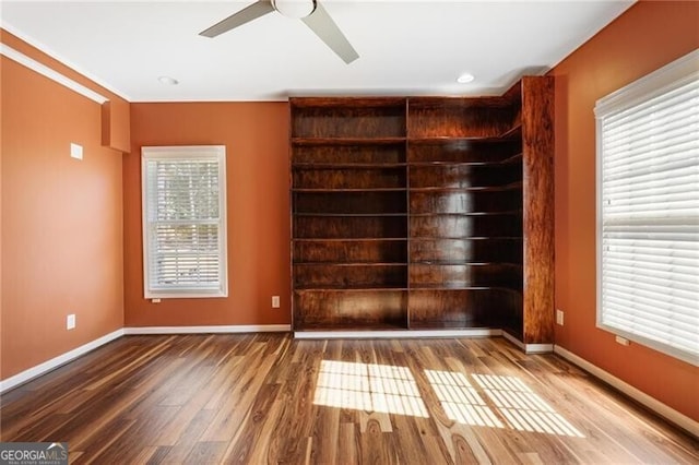 spare room featuring hardwood / wood-style floors and ceiling fan