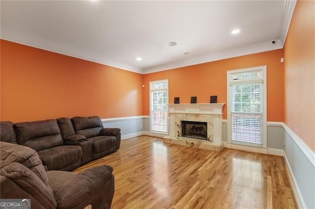 living room featuring crown molding, a wealth of natural light, and wood-type flooring