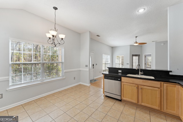 kitchen with pendant lighting, sink, light tile patterned floors, vaulted ceiling, and stainless steel dishwasher