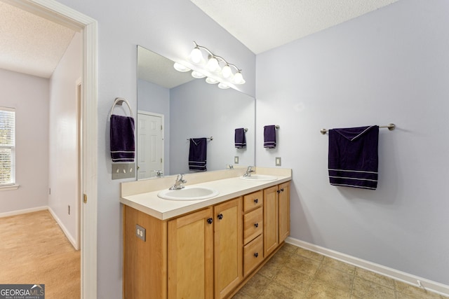 bathroom featuring vanity and a textured ceiling