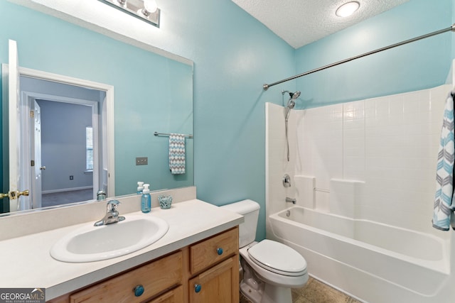 full bathroom featuring vanity, bathtub / shower combination, a textured ceiling, and toilet