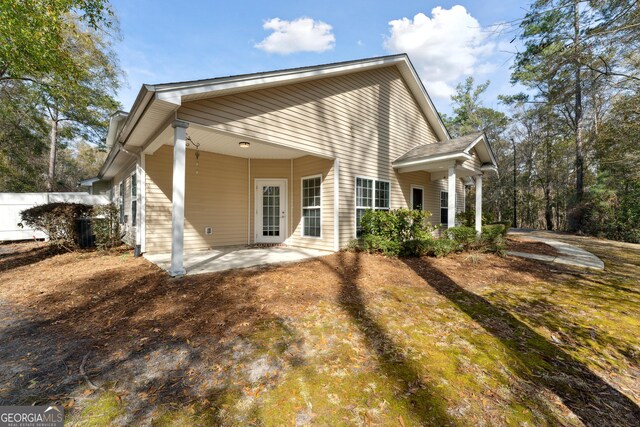 rear view of property featuring a patio area