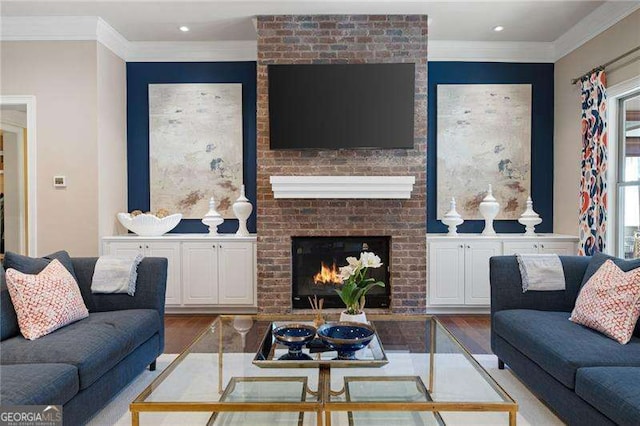 living room featuring ornamental molding, a brick fireplace, and light wood-type flooring